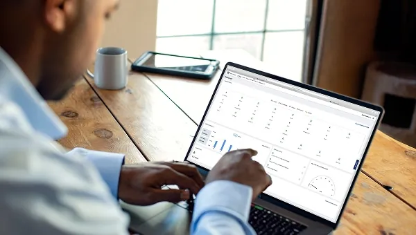 Fleet manager reviewing vehicle data on a laptop