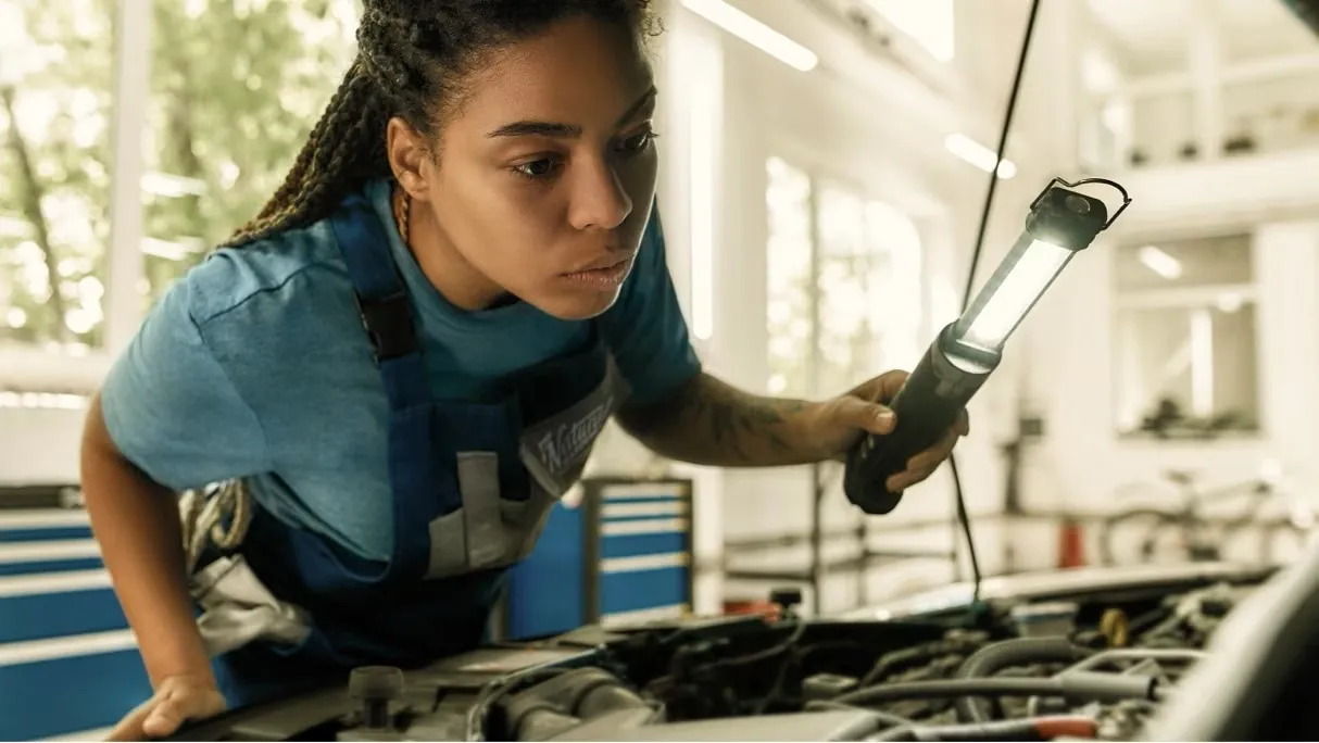 Peoria Ford technician inspecting an engine bay